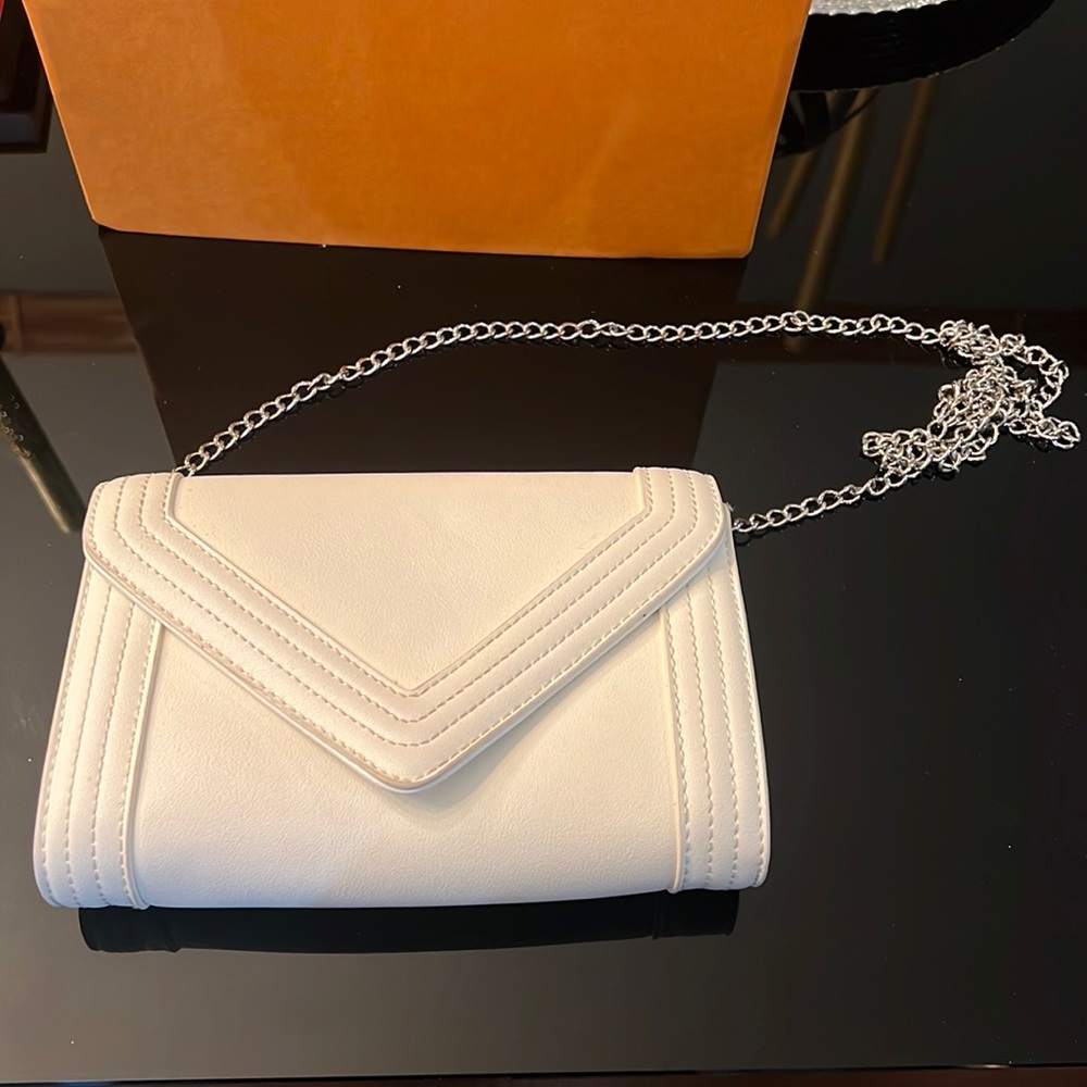 White Aldo clutch with silver chain